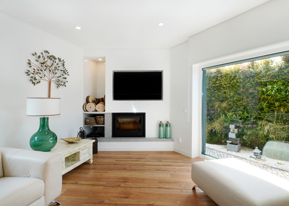 modern living room with fireplace and large window showcasing greenery and natural light featuring decorative tree artwork on wall and elegant furniture arrangement ideal for cozy gatherings and relaxation six ways to enhance home decor