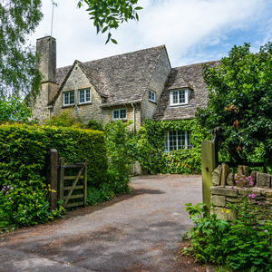 charming stone house surrounded by greenery with a winding path leading to a wooden gate showcasing beautiful gardens and a peaceful atmosphere ideal for a quaint escape with five seasons of nature