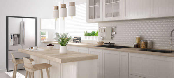 A light, simple kitchen with a wooden island