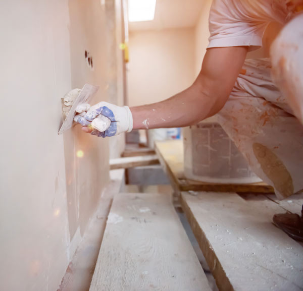 A man plastering a wall