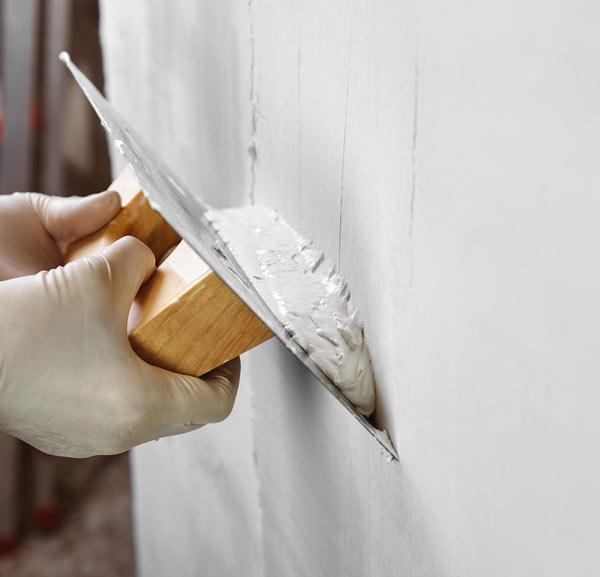 A man plastering a wall
