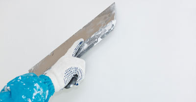 A man skimming a wall